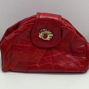 Red vintage embossed leather bag with gold brooch. Made in USA. Preowned